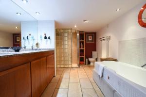 a large bathroom with a tub and a sink at Unique 2BR Old Forge in Central Portsmouth in Portsmouth