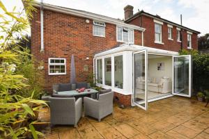an orangery and conservatory in front of a house at 4 BR Family Home w parking garden in Emsworth