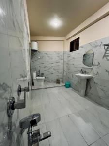 a bathroom with a sink and a toilet at Grham Hostel Kasol, Katagla in Kasol