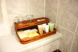 a tray with soap and other items on a shelf in a bathroom at Knight Armour Hotel in Dubai