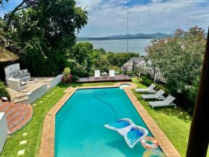 a swimming pool in the backyard of a house at ScenicViews@103 in Hartbeespoort +11 photos