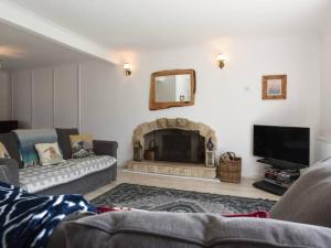 a living room with a couch and a fireplace at Large Family Home Private Garden Beach 2 mins Walk in South Hayling
