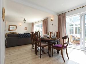 a dining room and living room with a table and chairs at Large Family Home Private Garden Beach 2 mins Walk in South Hayling