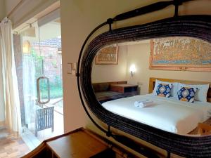 a bedroom with a large bed with a large mirror at S Bali Villa in Nusa Dua