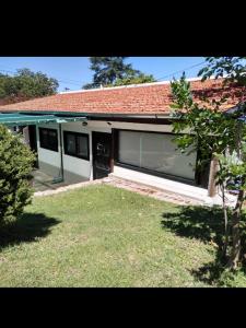 a house with a door and a grass yard at Mina's Apart in Mina Clavero +39 photos