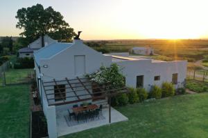 an aerial view of a white house with a table at Lowergroen Guestfarm, Working Farm in Swellendam