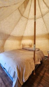 a bedroom with a bed in a tent at Glamping Río Serrano - Caja Los Andes in Puerto Natales