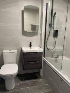 a bathroom with a toilet and a sink and a shower at Tootle Drive in Longridge