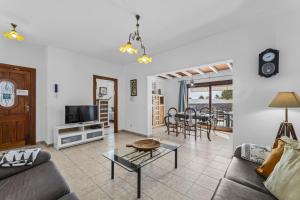 a living room with a couch and a table at Villa Bezanilla - VipVipVillas in Playa Blanca