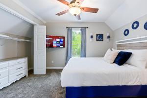 a bedroom with a bed and a ceiling fan at Fully Fenced & Stylish 3BR Near LakePoint Sports in Cartersville