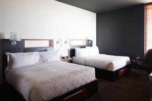 En eller flere senge i et værelse på Hôtel Alt Quartier DIX30