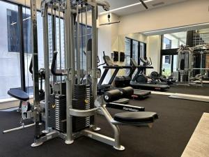 a gym with several treadmills and cardio machines at Sky View in Auckland