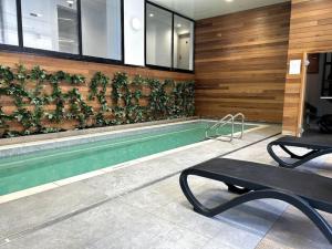 a swimming pool with plants on the wall at Sky View in Auckland