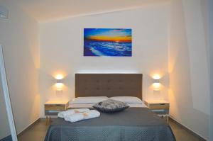 Postel nebo postele na pokoji v ubytování Valle degli Ulivi B&B