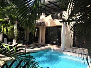 a swimming pool in the middle of a house at Typical villa , swimming pool, 300 Meters to Langosta Tamarindo beaches in Tamarindo