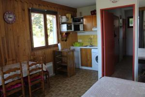 a kitchen with a table and a dining room at LA Source Blanche in Saint-Jean