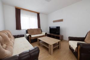 a living room with a couch and a tv at Apartman BARIŠIĆ 2 in Kupres