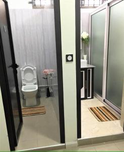 a bathroom with a toilet in a room at Serenity Villa in Balaclava