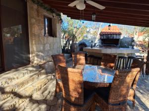 a patio with a table and chairs and a grill at Koukaki in Kouka