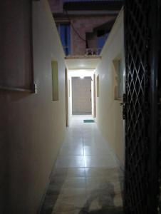 an empty hallway with a door leading into a room at King Bed "STUDIO ROOM"-Khalidiya Abudhabi in Abu Dhabi