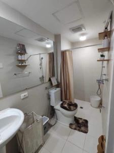 a bathroom with a toilet and a sink at Azure North Staycation by 7TwentySix CRIB in San Fernando