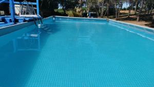 a large swimming pool with blue tiles on it at ZALUAY - Mobile Homes in Isla Cristina