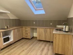 a large kitchen with a skylight in the ceiling at SeaAdrik in Bar