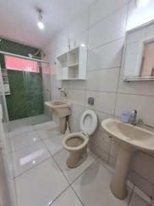 a bathroom with a toilet and a sink and a shower at Apartamento em Caiobá Matinhos próximo à Praia Brava! in Matinhos