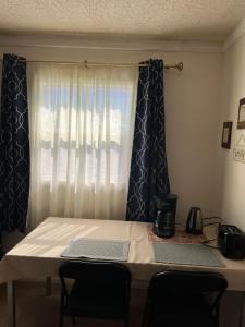 a table with chairs in front of a window at Executive Room in North Fort Myers