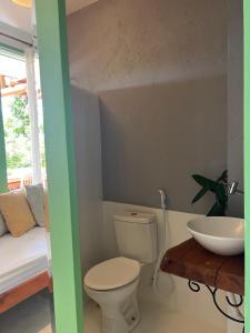 een badkamer met een toilet, een wastafel en een bed bij Locanda Ariramba in Santa Cruz Cabrália +159 foto's