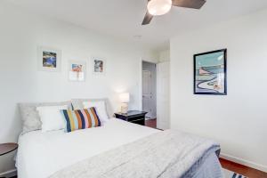 a white bedroom with a bed and a ceiling fan at Mystic Island Bay Breeze in Little Egg Harbor Township