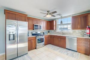 a kitchen with wooden cabinets and stainless steel appliances at Mystic Island Bay Breeze in Little Egg Harbor Township