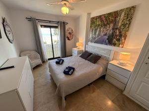 a bedroom with a bed and a large painting on the wall at 111 marina duquesa in Manilva +28 photos