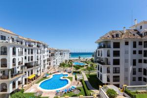 an apartment with a swimming pool and two buildings at 111 marina duquesa in Manilva