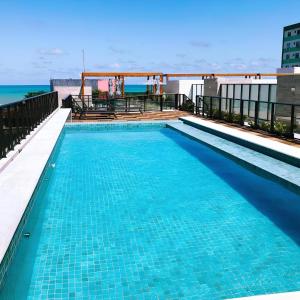 a swimming pool on the roof of a building at Eco Summer Tambaú - Apartamento de Alto Padrão de 2 Quartos in João Pessoa