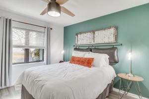 a bedroom with a large bed with a ceiling fan at Harrisonburg Home with Deck - 2 Mi to JMU! in Harrisonburg