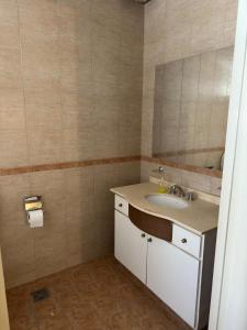 a bathroom with a sink and a mirror at Soleado Apart Hotel in San Rafael