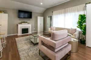 a living room with a couch and a fireplace at The Lilly Pad-Luxury in Sylvan Beach in Blossvale