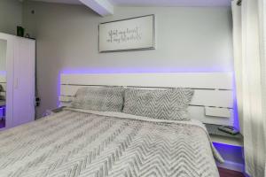 a bedroom with a bed with a white comforter at The Lilly Pad-Luxury in Sylvan Beach in Blossvale