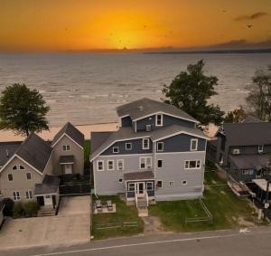 an aerial view of a large house and the water at The Historic Oneida Lake House - Condo 3 in Blossvale