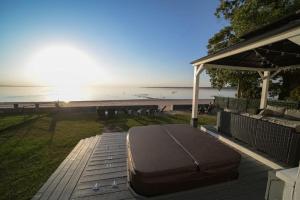a mattress sitting on a deck near the beach at The Historic Oneida Lake House - Condo 3 in Blossvale