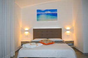 Postel nebo postele na pokoji v ubytování Valle degli Ulivi B&B