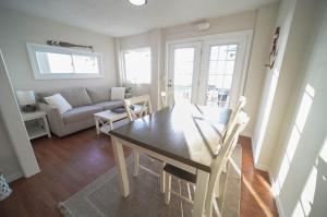 a living room with a table and a couch at The Historic Oneida Lake House - Condo 2 in Blossvale
