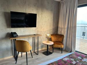 TV a/nebo společenská místnost v ubytování Hôtel Casa Matteu