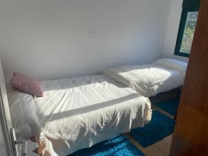 a bedroom with two beds and a window at BAHIÑA MAR in Baiona