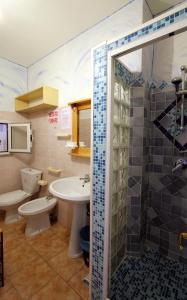 e bagno con lavandino, servizi igienici e doccia. di B&B Sa Bèrtula a La Maddalena