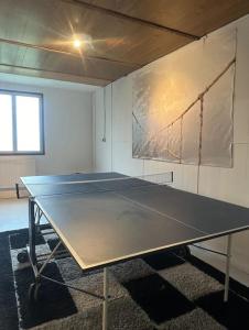 una mesa de ping pong en una sala con aversión en Charmante maison 10 mn Center Parcs Ailette en Laon