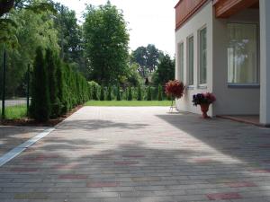 a brick driveway next to a house with flowers on it at Exclusive Mansion Jurmala in Jūrmala