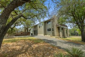 an exterior view of a house with a tree at Wine Country Retreat – with a lake view! in Spicewood