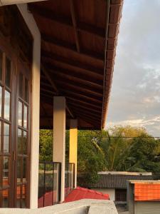 a building with a wooden roof and a glass door at Sunshine Holiday Home at Wattala in Wattala